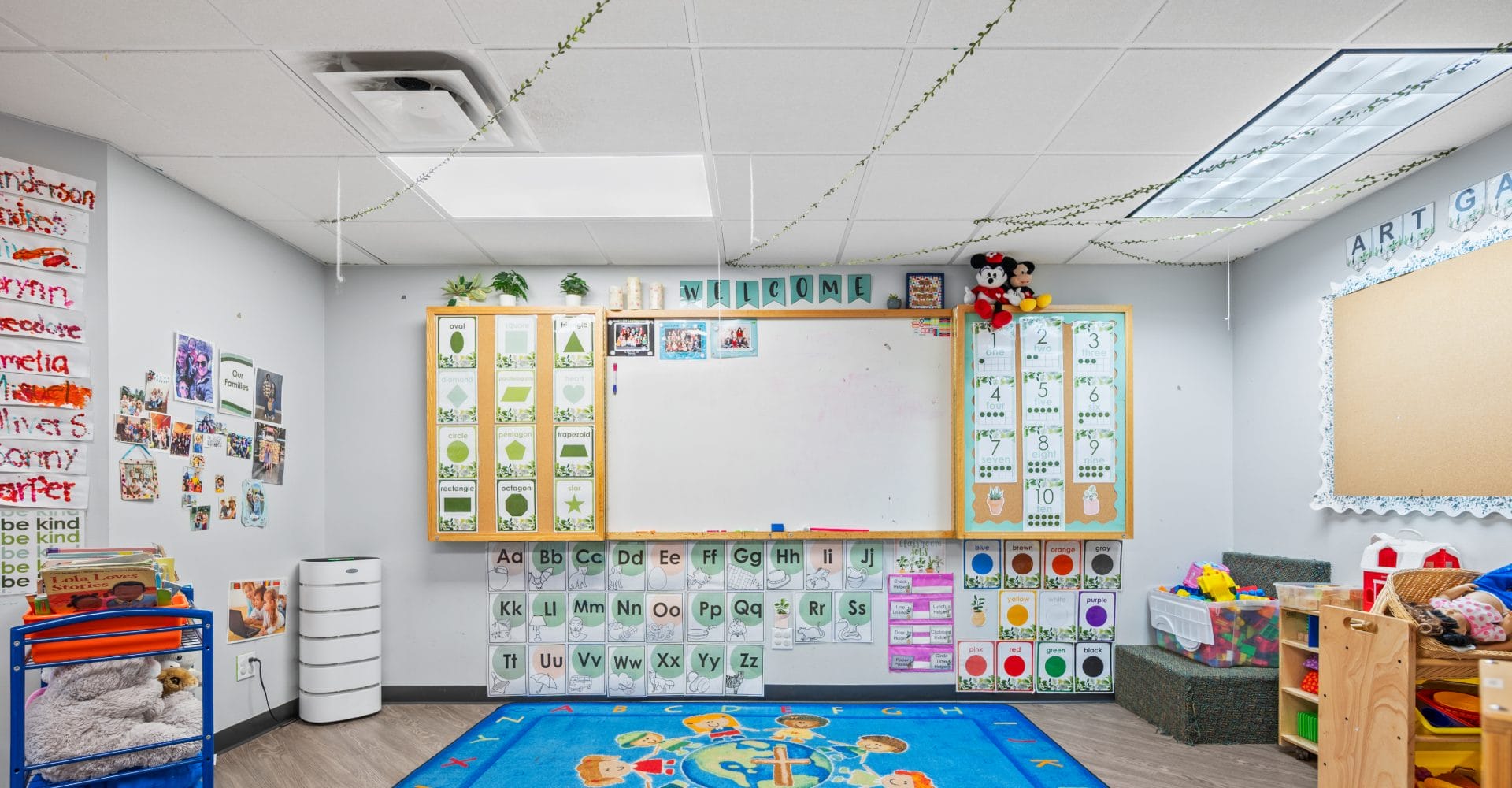 Preschool classroom with alphabet rug and calendar wall